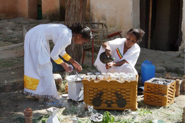 Two women performing a coffee ceremony in Ethiopia