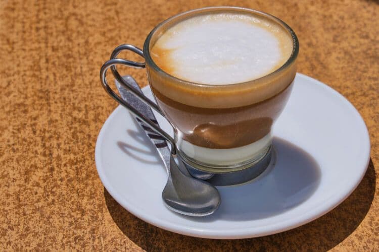 A brown coffee on a white saucer in Spain.