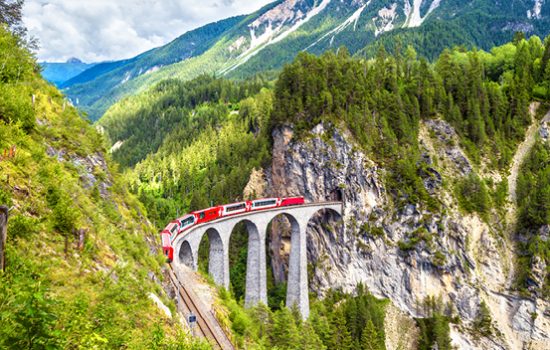 The Glacier Express travelling on a bridge in Switzerland