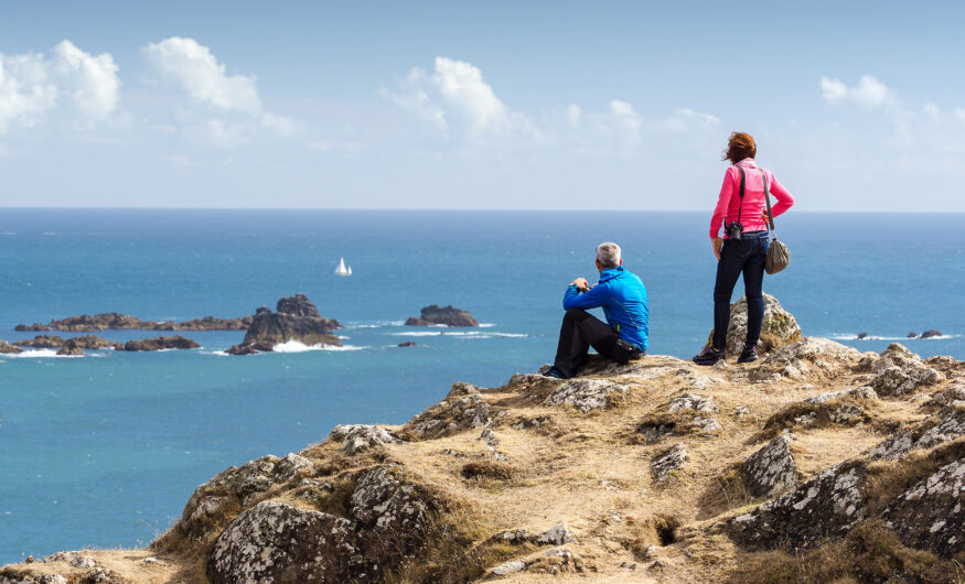 Two people on a hill with a wonderful view of the sea