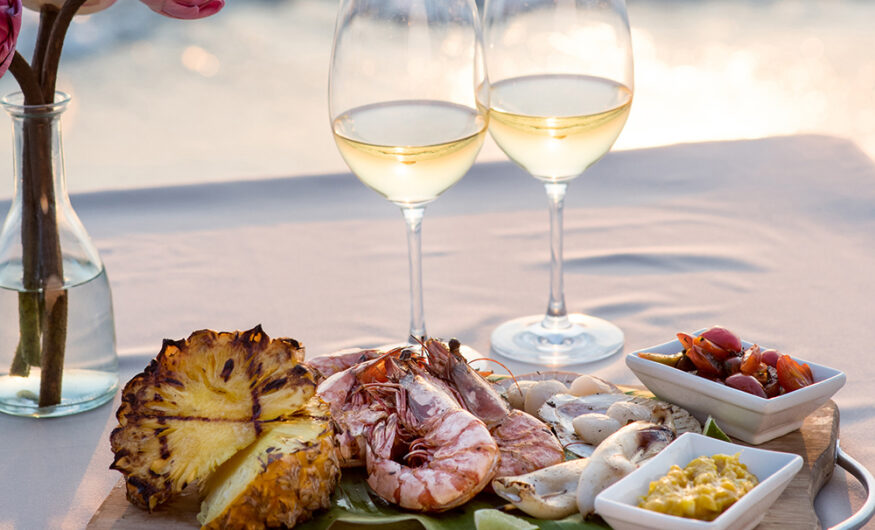 Wine and seafood on a table by the sea